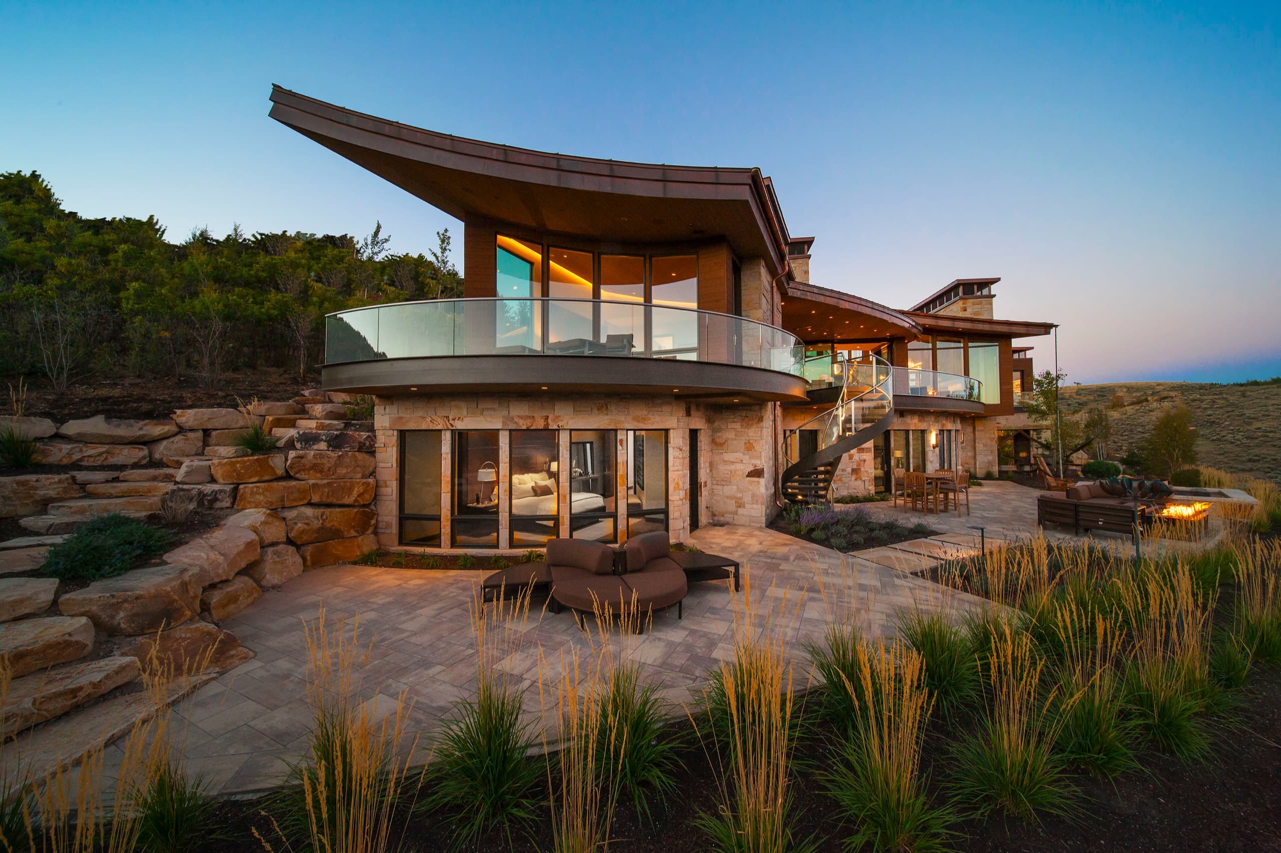 Crescent House, a Build Hill custom home in Park City, Utah, terraced into its hillside with boulder walls